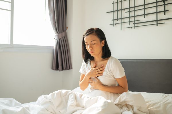 morning sickness young pregnant woman sitting bed covering her mouth feeling nauseous during pregnancy woman white pajamas suffering from acid reflux while wake up her bed morning min