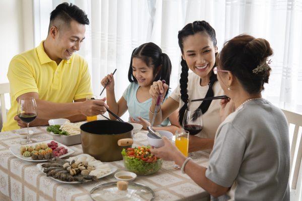 medium shot family sitting table